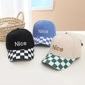 Detailed shot of kids baseball caps in black, blue and beige with Nice embroidery