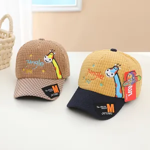 Detail of baby baseball cap featuring giraffe embroidery and corduroy texture on visor