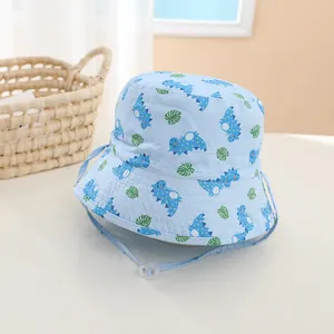Detail of baby sun hat with blue dinosaur prints and adjustable chin strap cord
