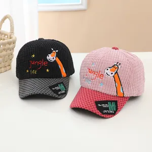 Close-up of corduroy baby baseball caps with giraffe embroidery and plaid brims