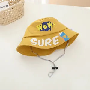 Detail of yellow cotton kid bucket hat featuring blue dinosaur print and windproof cord