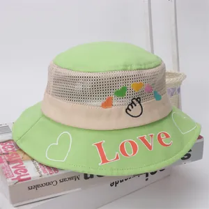 Detail of green mesh bucket hat with red Love embroidery and heart patterns for kids