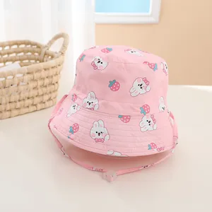 Detail of pink cotton baby sun hat with cute bunny and strawberry prints and windproof strap