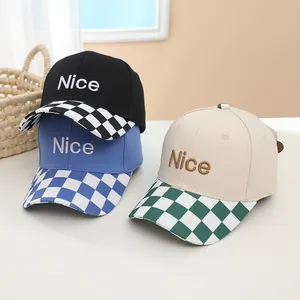 Detailed embroidery of 'Nice' text on cotton baseball caps with checkerboard brims