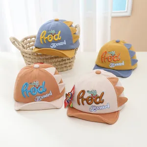 Detail of baby dinosaur baseball caps in four colors featuring 3D fins and cute embroidery