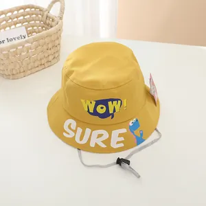 Close-up of kids yellow fisherman hat with WOW lettering and cute dinosaur print