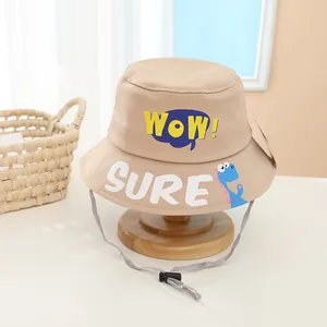 Detail of kids bucket hat with WOW embroidery, cartoon dinosaur and adjustable chin strap