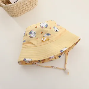 Detail of baby sun hat featuring unicorn print, adjustable drawstring and windproof strap