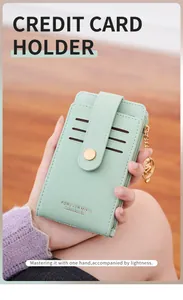 Close-up of mint green PU leather card holder with snap closure and gold zipper detail