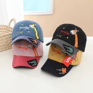 Detail of colorful corduroy kids baseball caps with giraffe embroidery and plaid textures