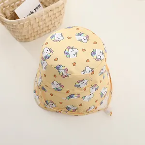 Detail of yellow children's bucket hat with unicorn prints and adjustable chin strap