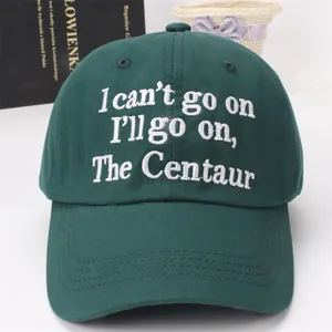 Detail of embroidered white text on dark green canvas baseball cap with reinforced stitching