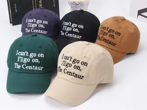 Detail of embroidered cotton baseball caps in navy, black, yellow, and green colors