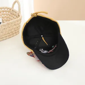 Detailed inner view of ginger corduroy baseball cap with six-panel stitching and brand tag