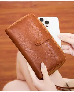 Close-up of brown litchi pattern leather wallet with phone storage and zipper detail