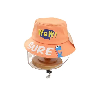 Kids orange fisherman hat with WOW lettering and detachable face shield on wood tray