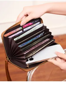 Macro view of brown long zipper wallet with multi-layer accordion compartments for phone and cards