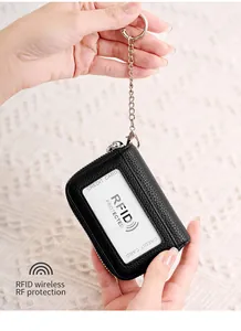 Detail of black pebbled leather RFID card holder with silver chain and key ring