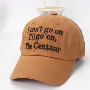 Close-up of caramel cotton baseball cap featuring black embroidered quote on front