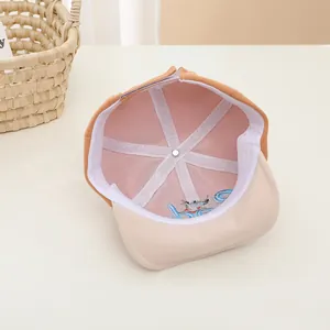 Detailed interior of infant baseball cap showing pink lining and cartoon mouse embroidery