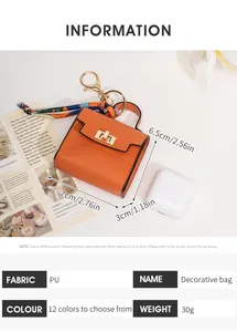 Detail view of orange PU leather mini bag charm with silk scarf and gold twist lock