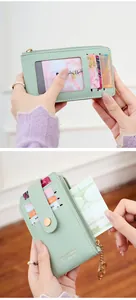 Detail of mint green PU leather wallet featuring card slots and gold zipper hardware