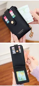 Detail of black pebbled PU leather card wallet with gold hardware and zipper pocket