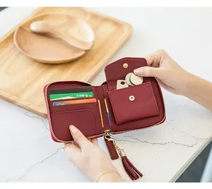 Detailed interior of burgundy zip wallet showing card slots and snap coin pocket