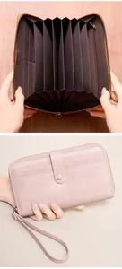 Detail view of pink long wallet with accordion compartments and multi-card slots