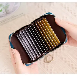Detail of teal RFID blocking card holder with 11 accordion slots and metal keychain