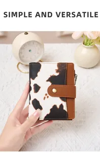 Detail of a bifold cow print wallet with RFID protection and brown leather texture
