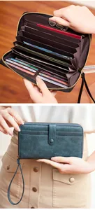 Detail of vintage women's long wallet showing multi-card slots and red zipper pocket