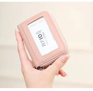 Close-up of pink litchi grain leather card holder with RFID protection and zip closure