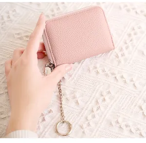 Detail of pink RFID leather card holder with litchi texture and metal keychain
