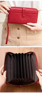 Detail of red vintage long wallet showing accordion compartments and card slots
