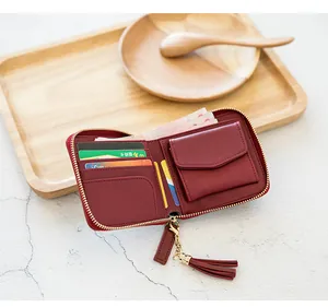 Inside view of a deep red zip-around wallet with card slots and tassel zipper detail