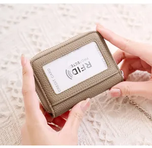 Detail view of khaki RFID leather wallet with transparent ID card slot and metal chain