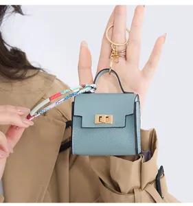 Mini light blue leather bag keychain with golden lock and colorful silk scarf detail