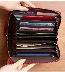 Internal view of red leather long wallet showing multi-card slots and passport capacity