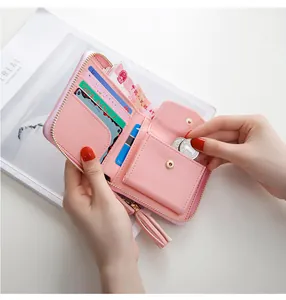 Detail view showing internal card slots and coin pocket of pink faux leather wallet