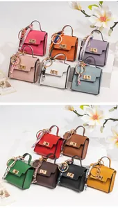Miniature leather handbags with golden hardware and floral scarves in various colors