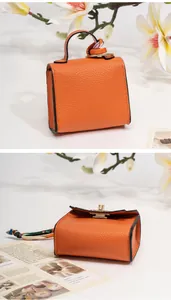 Miniature orange pebbled leather bag charm with floral silk scarf handle and gold lock
