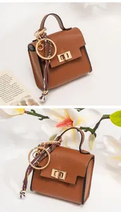 Mini caramel leather handbag keychain with printed scarf detail and gold hardware