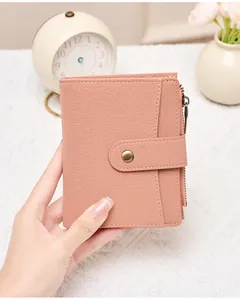 Pink RFID leather wallet detail with lychee texture and secure metal zipper pocket
