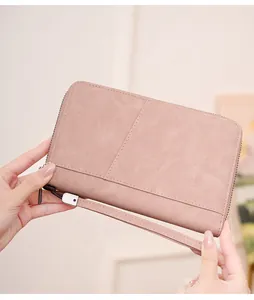 Close-up of pink RFID blocking passport wallet with matte texture and wrist strap