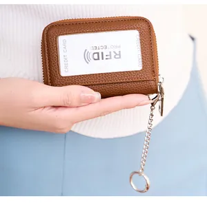 Macro view of brown lychee leather RFID wallet with card slot and metal chain