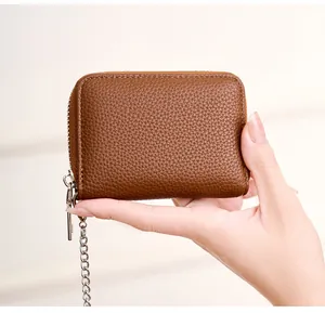 Detailed shot of brown litchi leather RFID card wallet with silver zipper and chain
