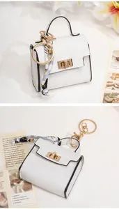 Miniature white pebble leather handbag keychain with silk scarf detail and gold hardware