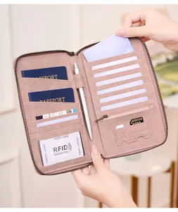 Detail view of pink RFID blocking passport travel wallet with card slots and pen holder