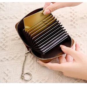 Detailed view of brown accordion card holder with metal chain and multiple slots